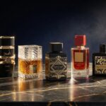 Luxurious arrangement of best lattafa perfumes bottles including Asad, Khamrah, and Bade’e Al Oud Oud for Glory on a dark marble background