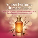 Featured image of a luxurious glowing amber perfume bottle with warm golden liquid, rose-pink gradient background, text overlay: Amber Perfume Ultimate Guide – Smell Like Clive Christian Blonde Amber – Best Budget Dupes Under $60